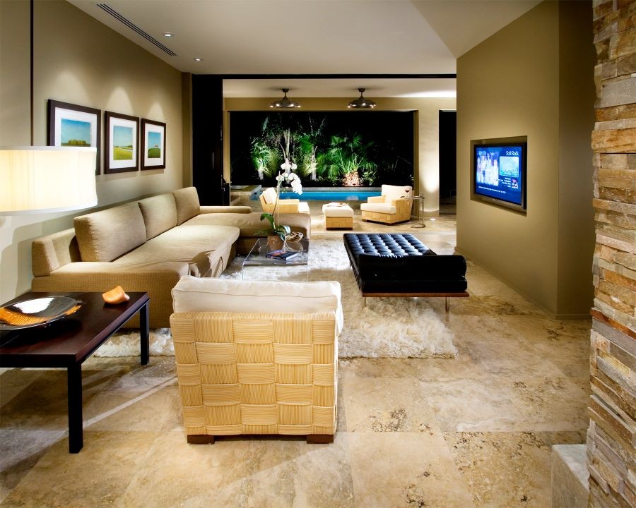 A living area with a flat-screen TV looking out onto the pool.