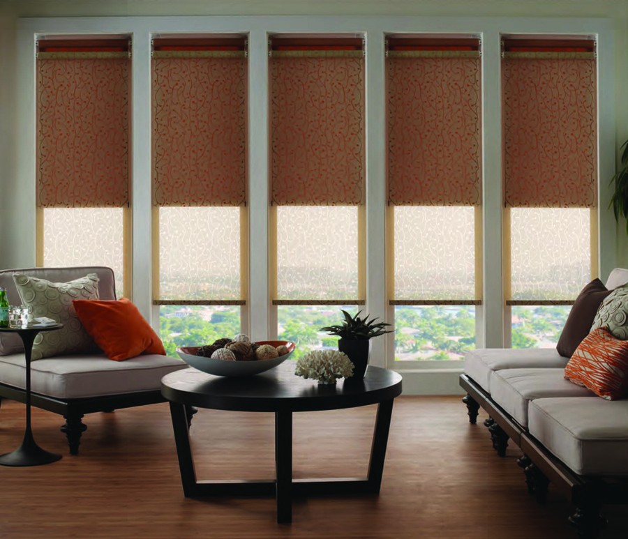 a living room with a round table and motorized shades 