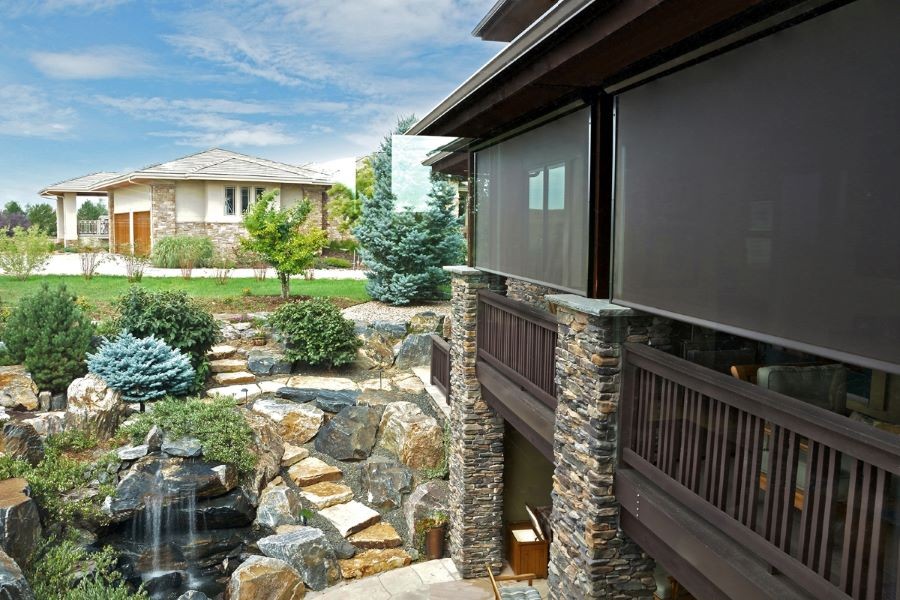 Insolroll motorized outdoor shades lowered around a patio.