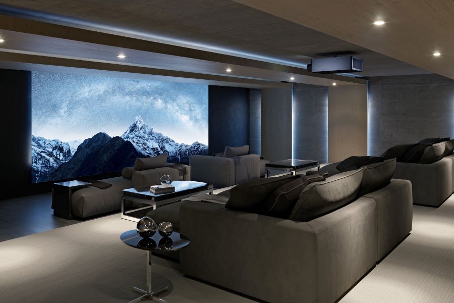 A home theater with a large movie screen, Sony projector, and plush chaise lounges.