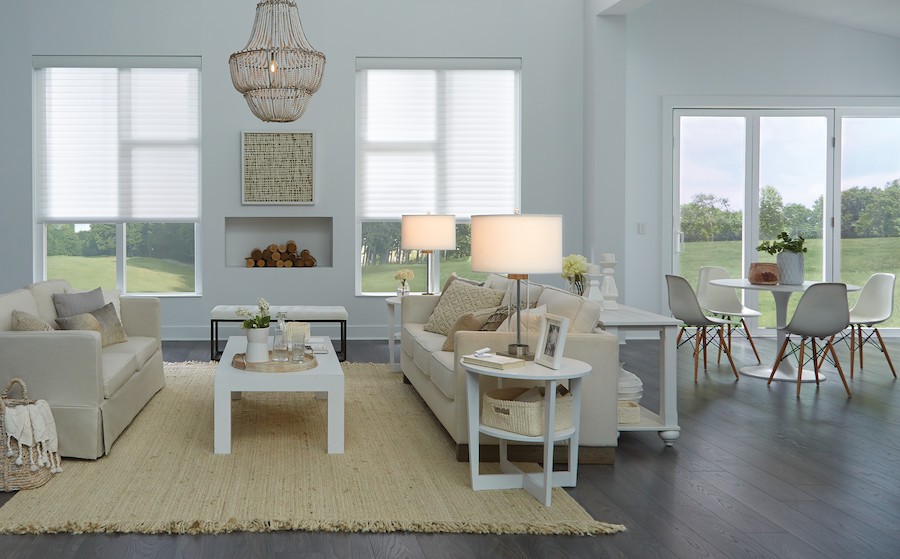 A serene bedroom with large windows and motorized shades.