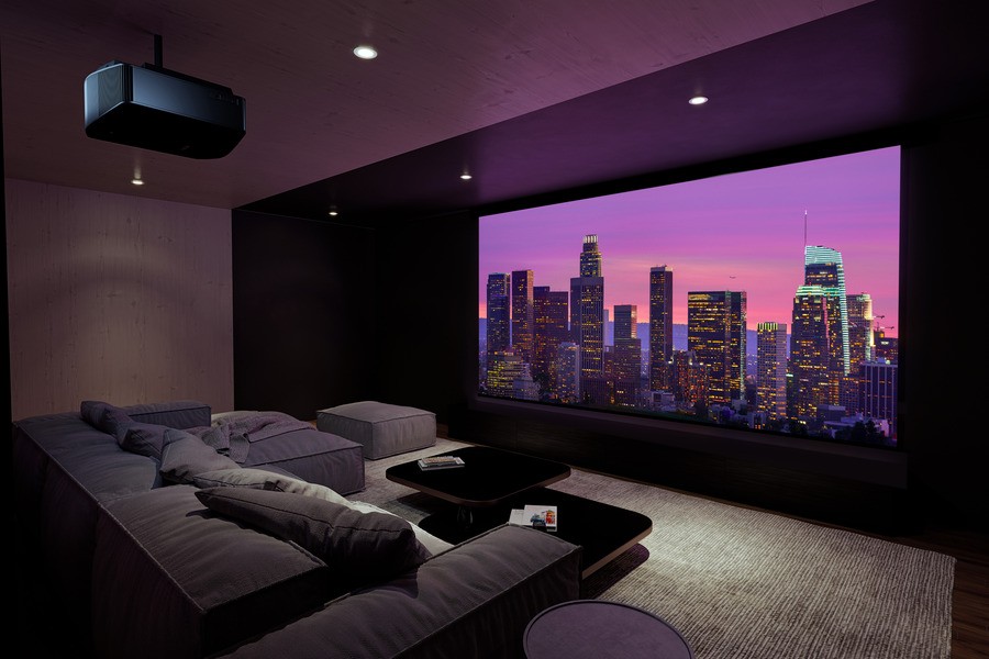 Modern home theater room with oversized plush seating and a large projector screen displaying a city skyline at dusk.
